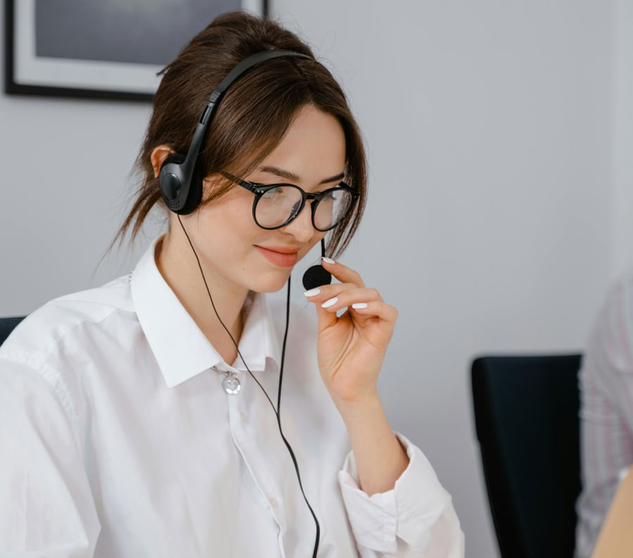 Professional woman using headset for customer service in office setting.